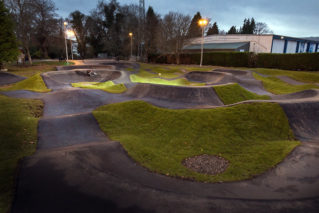 Inverness pump track at dusk with floodlights on